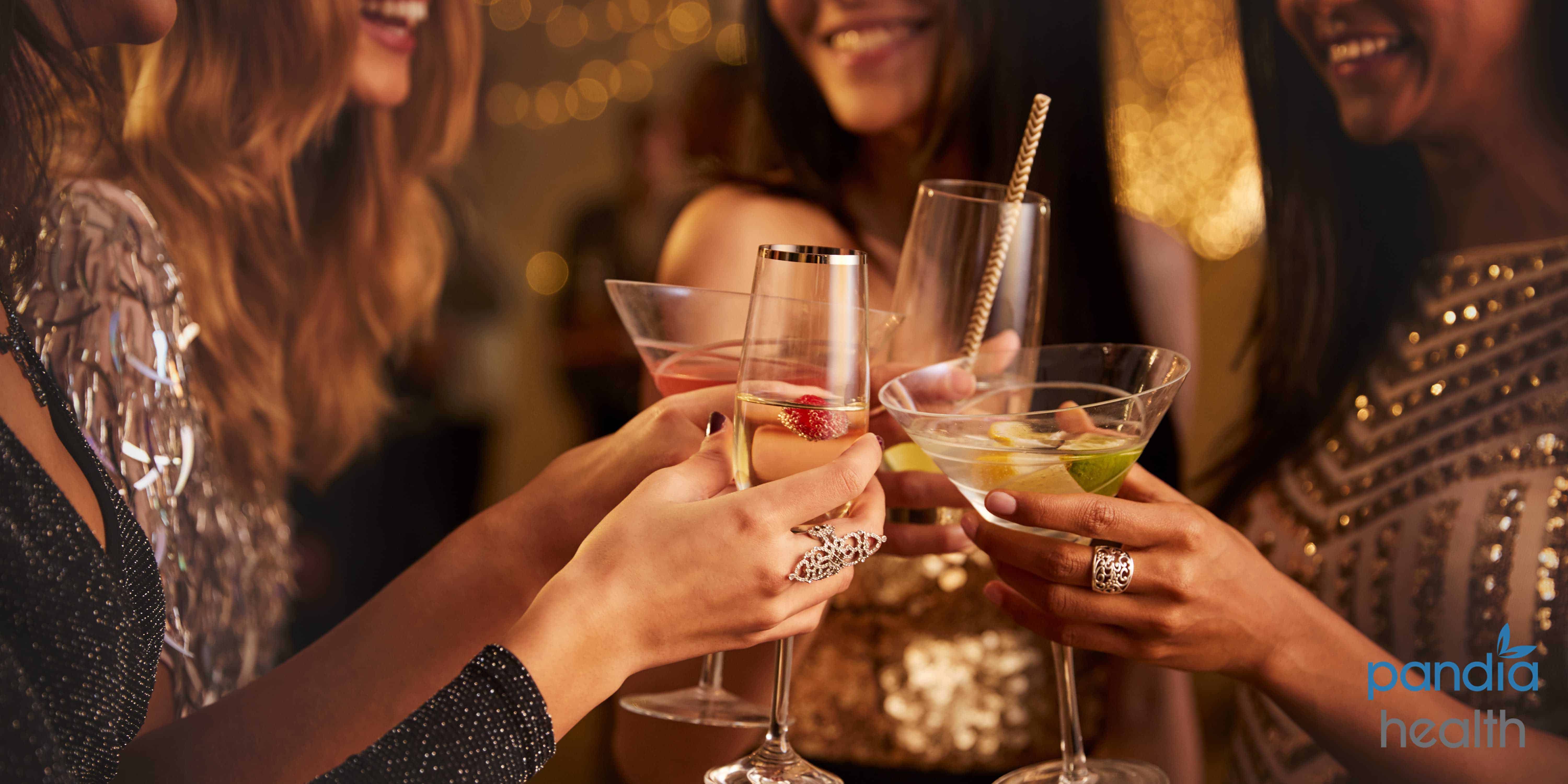 Woman at NYE party holding drinks