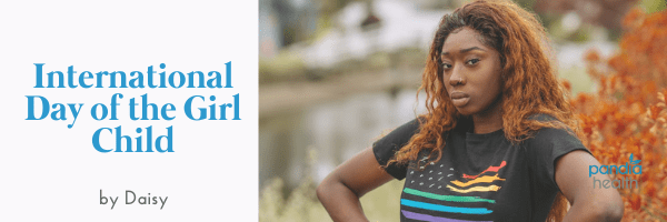 empowered black woman staring fiercely into camera wearing a pride shirt