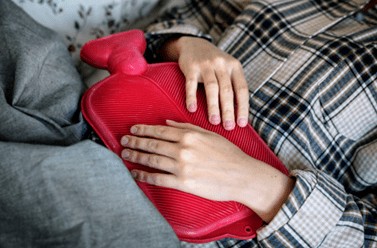Heat applied to lower abdomen to relieve period pain