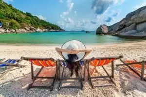 Woman Relaxing On Beach Despite Period