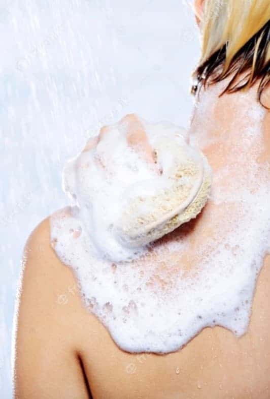 Woman exfoliating back to get rid of back acne (1)