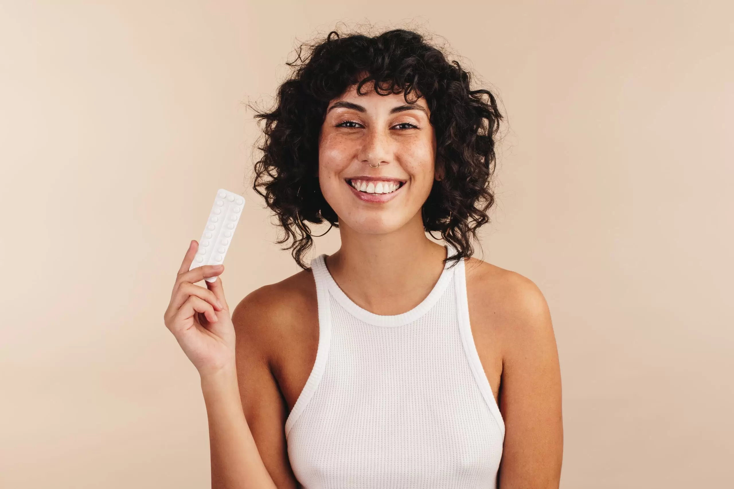Woman holding a packet of Aurovela vs Junel birth control 