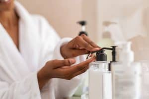 A woman dispensing a product into her hand