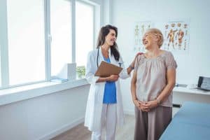 doctor laughing with a patient at the consult's room