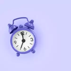 Purple clock against a purple background