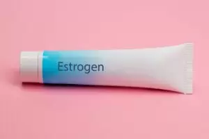 photo of a Estrogen cream tube on a pink background